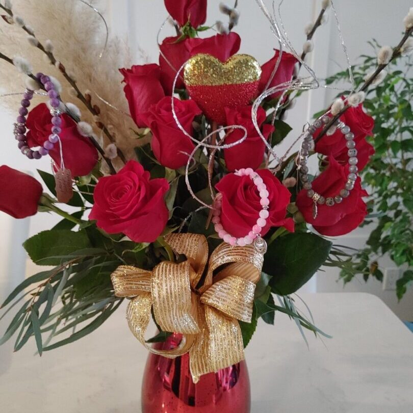 A red case with red roses, a ribbon, and shiny decorations
